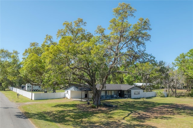 view of front facade featuring a front yard and fence