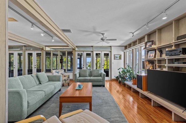 sunroom / solarium featuring french doors, visible vents, and a healthy amount of sunlight