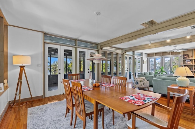 dining area with french doors, visible vents, wood-type flooring, and baseboards