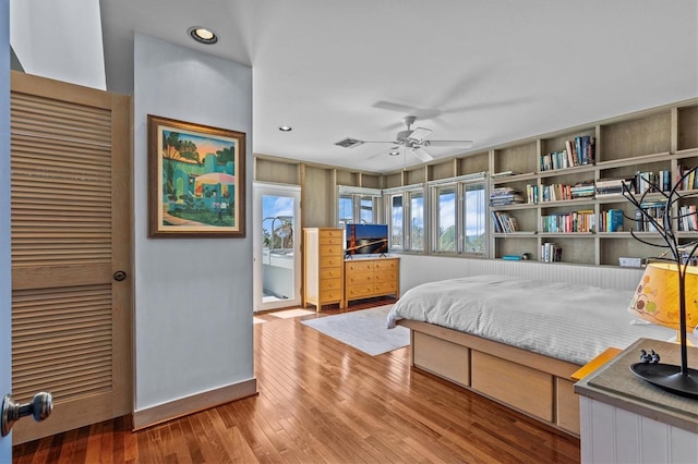 bedroom featuring a closet, hardwood / wood-style floors, and recessed lighting