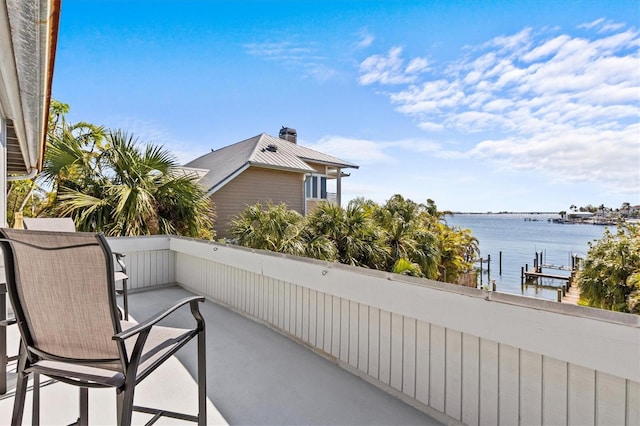 balcony featuring a water view and a dock