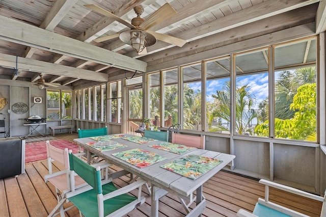 sunroom featuring beam ceiling, wooden ceiling, and a ceiling fan