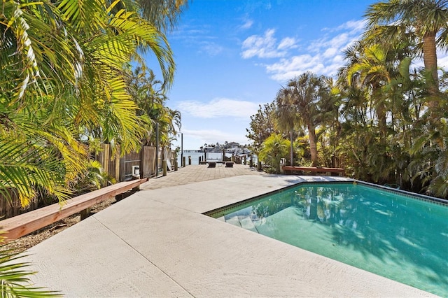 pool featuring a patio area and fence