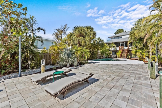 pool featuring stairs, a patio, and fence