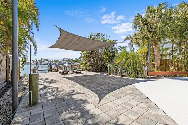 view of patio / terrace featuring a boat dock and fence