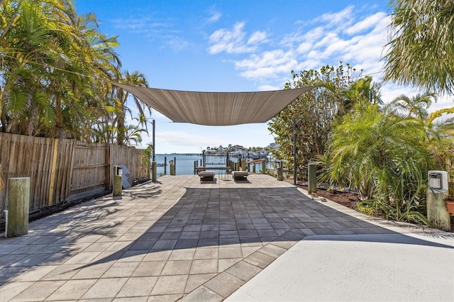 view of patio / terrace featuring a boat dock and fence