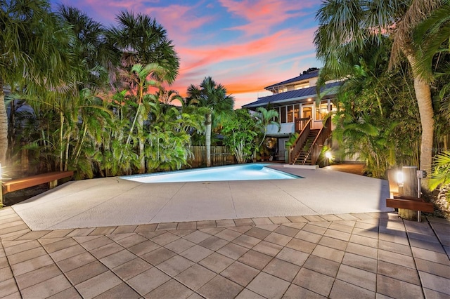 pool featuring a patio area and stairway