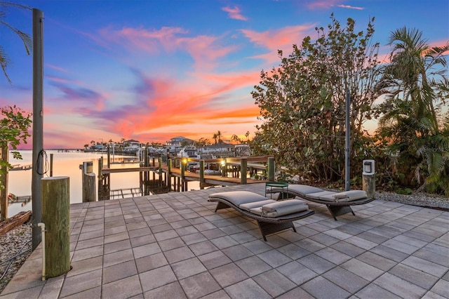 view of patio with a water view, a boat dock, and boat lift