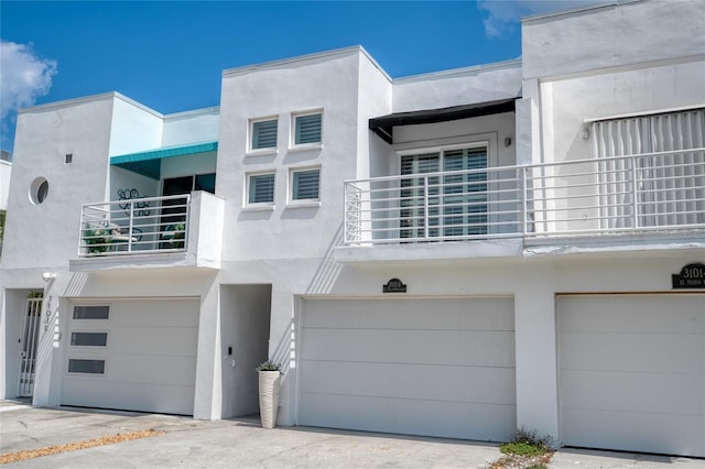 3101 W El Prado Blvd Unit B, Tampa, FL 33629 - view of front of house with a balcony, a garage, and stucco siding