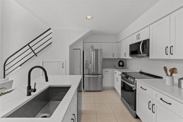 3101 W El Prado Blvd Unit B, Tampa, FL 33629 - kitchen with appliances with stainless steel finishes, a sink, white cabinetry, light tile patterned flooring, and recessed lighting