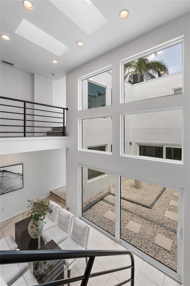 3101 W El Prado Blvd Unit B, Tampa, FL 33629 - staircase with tile patterned floors, a skylight, and recessed lighting