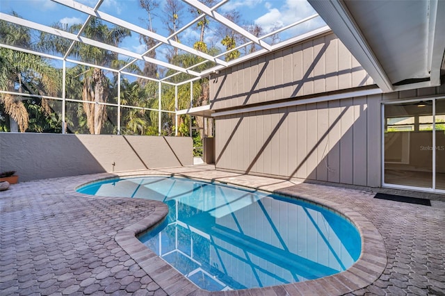 outdoor pool featuring a patio area and a lanai