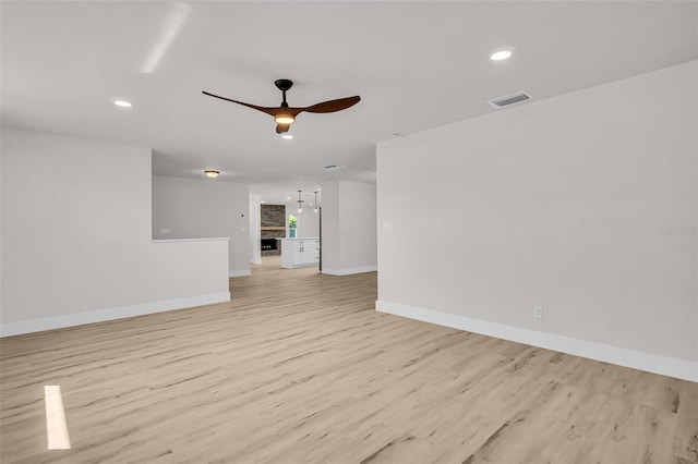 empty room featuring visible vents, baseboards, light wood-style flooring, ceiling fan, and recessed lighting