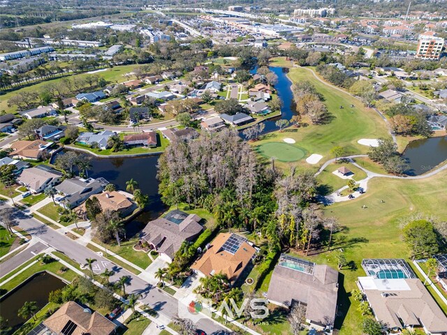 bird's eye view featuring golf course view, a water view, and a residential view