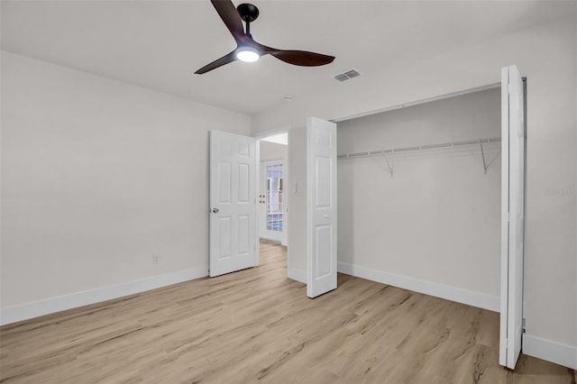 unfurnished bedroom featuring a closet, visible vents, light wood-style flooring, and baseboards