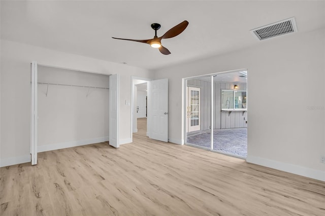 unfurnished bedroom with visible vents, ceiling fan, baseboards, and wood finished floors