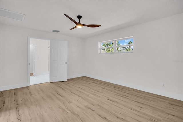 interior space featuring a ceiling fan, baseboards, visible vents, and wood finished floors