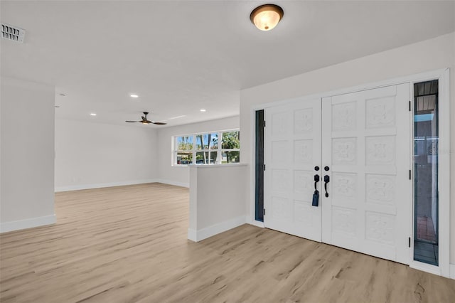 foyer with light wood-style flooring, visible vents, baseboards, and recessed lighting