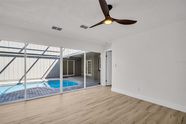 outdoor pool featuring a ceiling fan