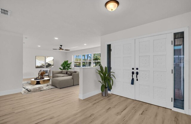 foyer with light wood-type flooring, visible vents, baseboards, and recessed lighting