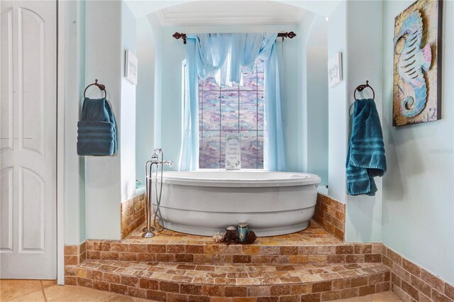 bathroom featuring a soaking tub and tile patterned flooring