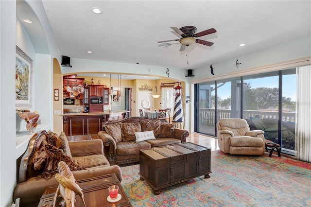 living room featuring a ceiling fan and recessed lighting