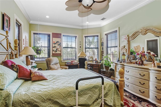 bedroom with ceiling fan, visible vents, and crown molding