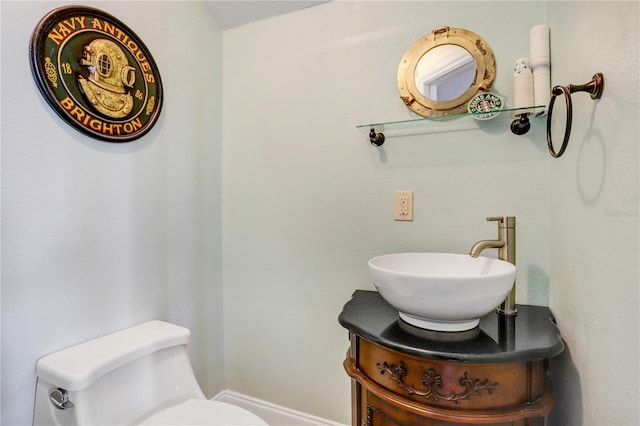 bathroom featuring vanity and toilet