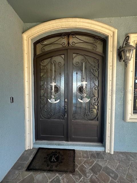 property entrance with stucco siding