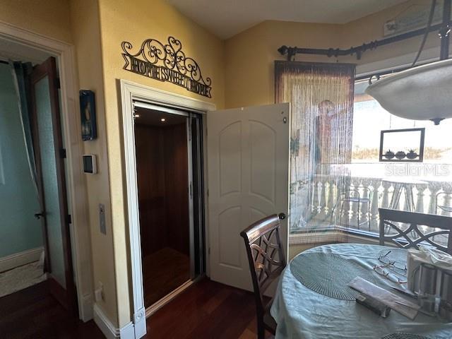 dining room with baseboards and wood finished floors