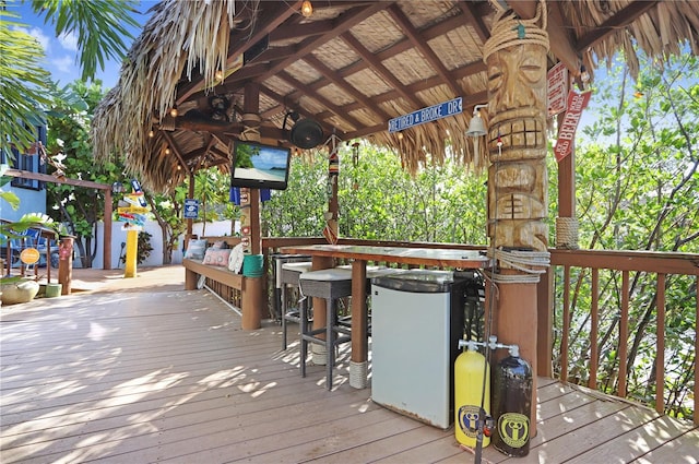 wooden deck featuring outdoor dry bar