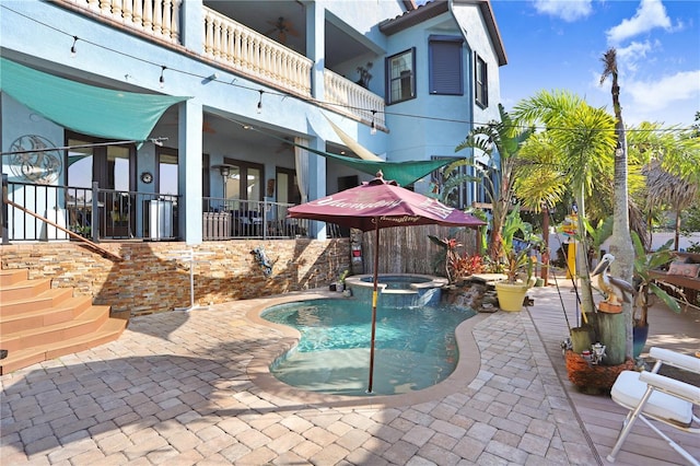 view of swimming pool with a patio area, a pool with connected hot tub, and ceiling fan