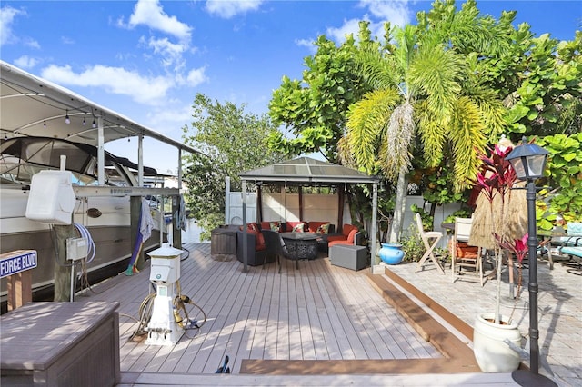 wooden terrace featuring outdoor dining area and a gazebo