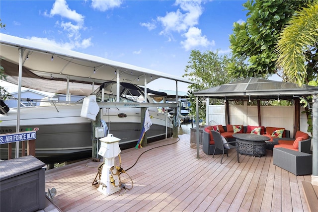 dock area featuring boat lift, a gazebo, and an outdoor hangout area