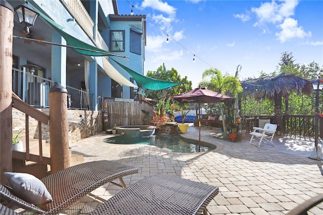 view of patio / terrace with a pool with connected hot tub