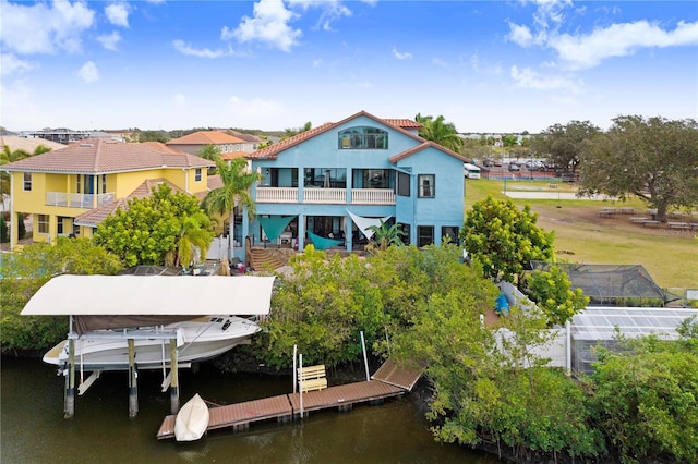 back of property featuring a water view and boat lift