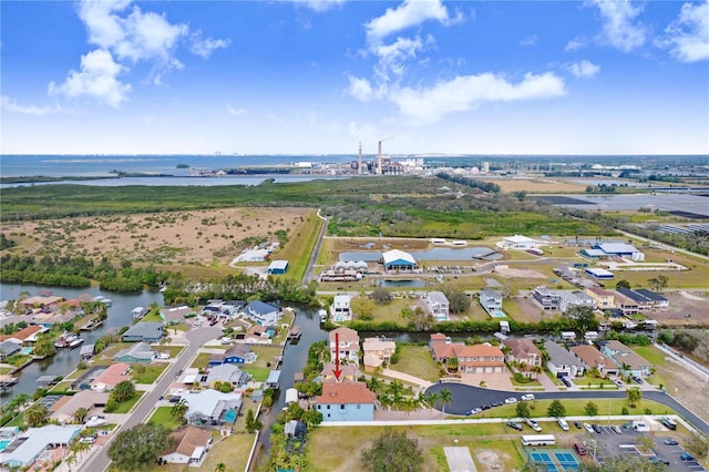 drone / aerial view featuring a water view and a residential view