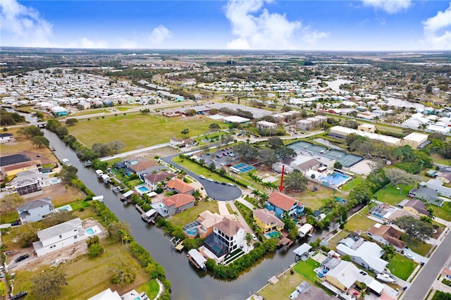 drone / aerial view featuring a residential view and a water view