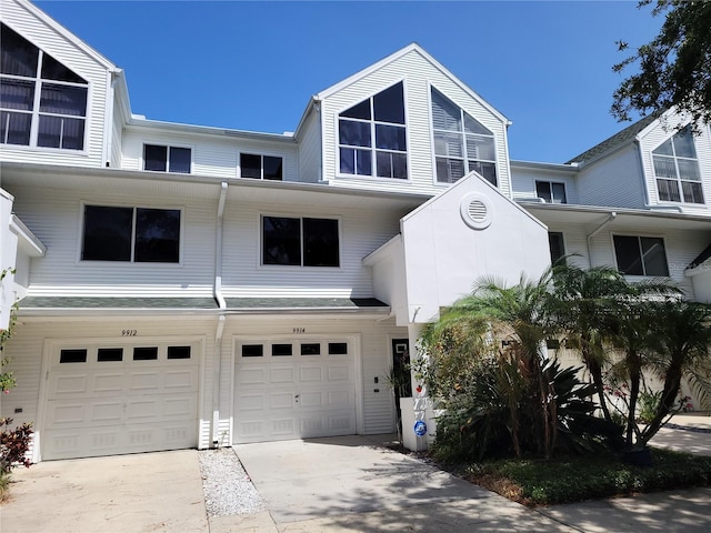 townhome / multi-family property featuring driveway and an attached garage