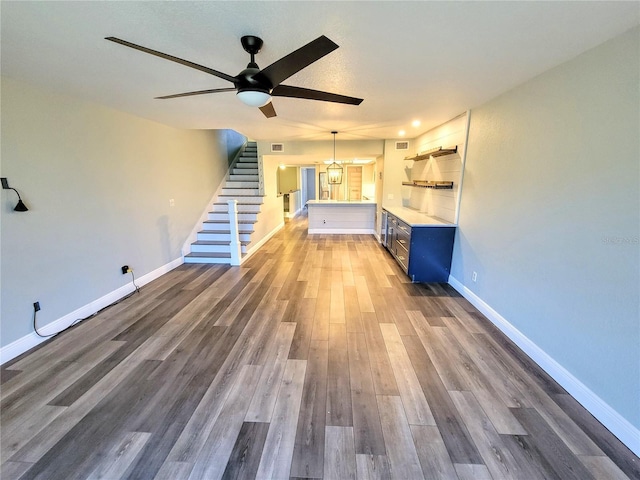 unfurnished living room featuring baseboards and wood finished floors