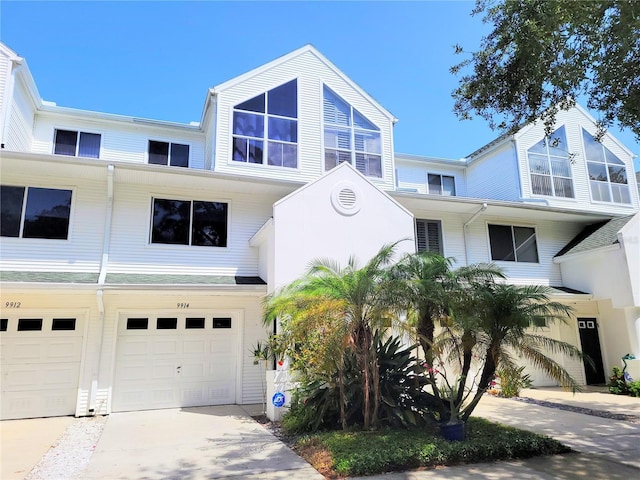 townhome / multi-family property featuring a garage and concrete driveway