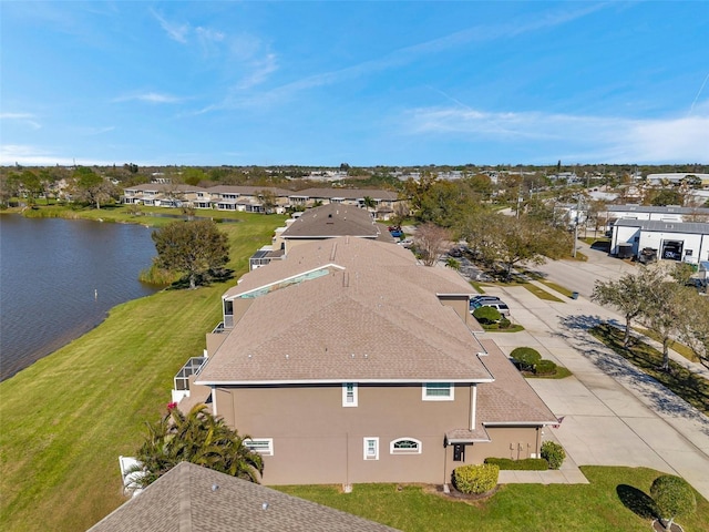 drone / aerial view featuring a water view and a residential view