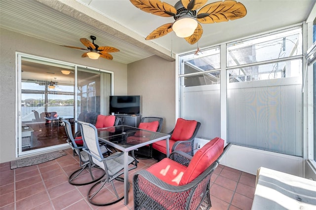 sunroom featuring a ceiling fan