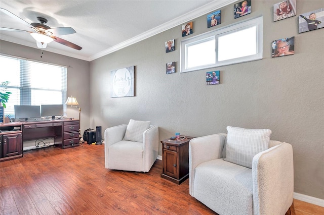 living area featuring a textured wall, ornamental molding, dark wood-type flooring, and a wealth of natural light