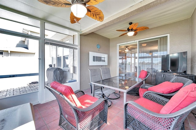 sunroom / solarium with a ceiling fan