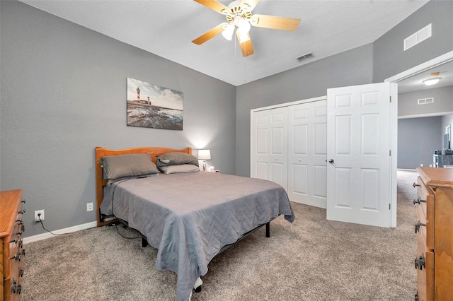 carpeted bedroom with baseboards, visible vents, and a closet