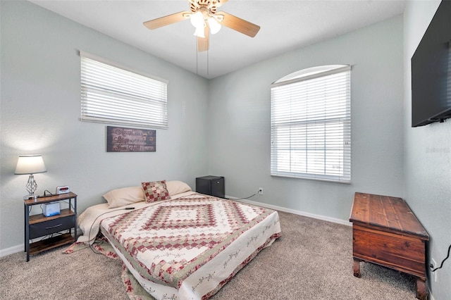 carpeted bedroom with a ceiling fan and baseboards