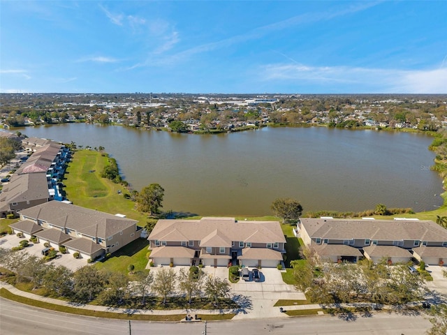 birds eye view of property with a water view and a residential view