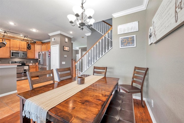 dining area with a notable chandelier, recessed lighting, stairway, ornamental molding, and baseboards