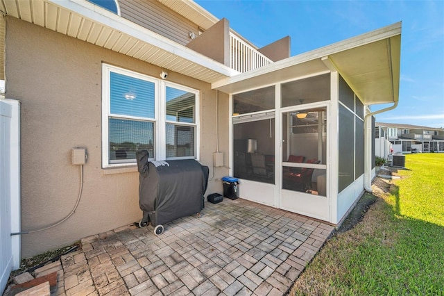 view of patio / terrace with a balcony, a sunroom, cooling unit, and area for grilling